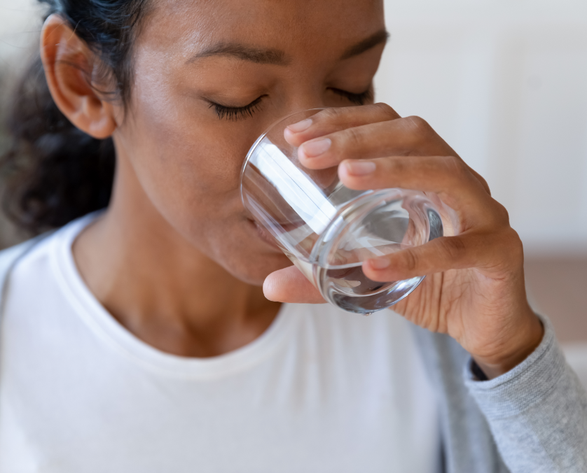 a woman drinking a glass of water.