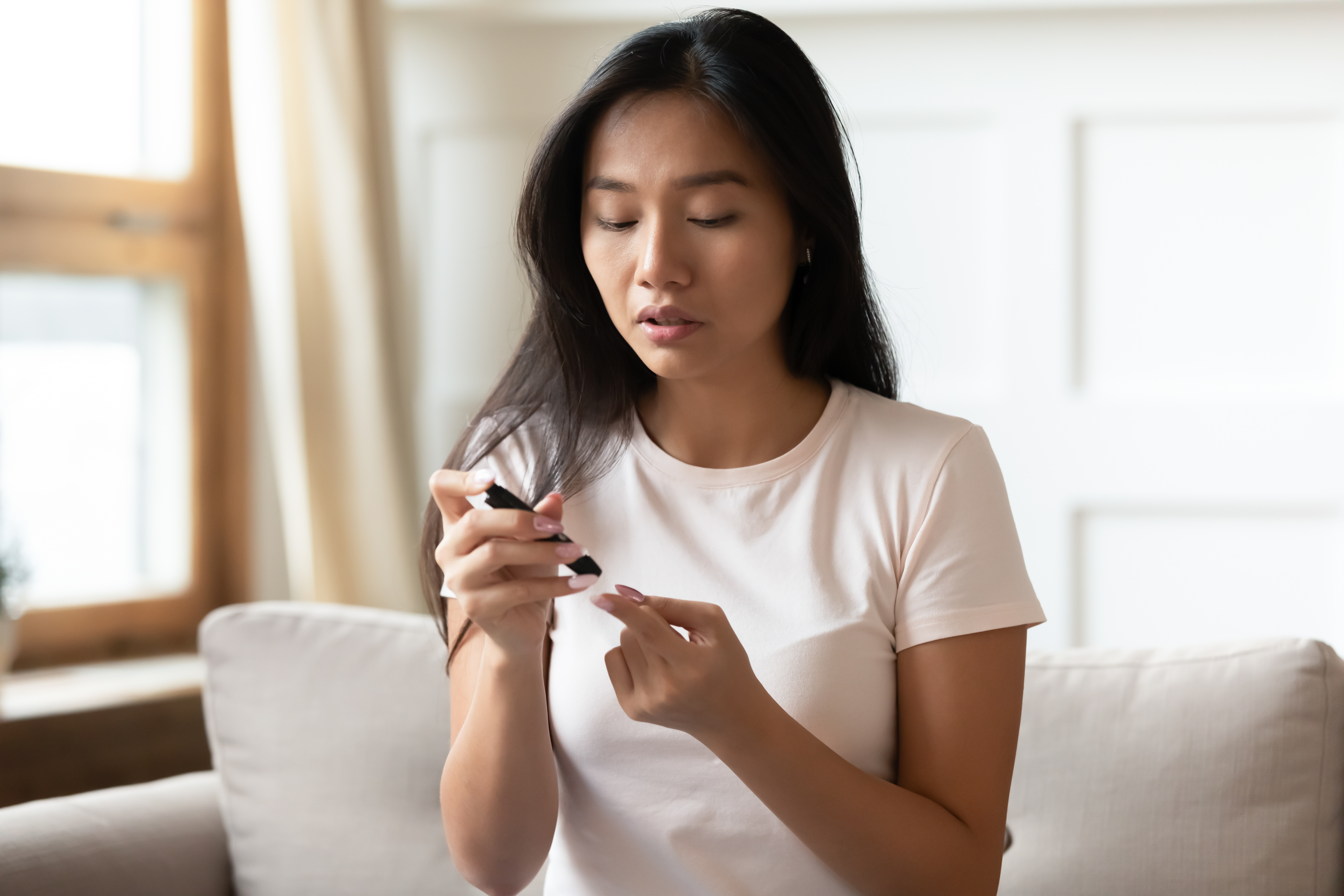 a woman testing her blood sugar